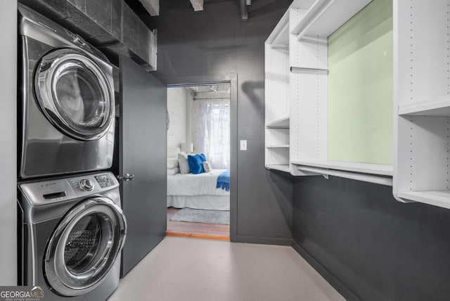 washroom with stacked washer and clothes dryer