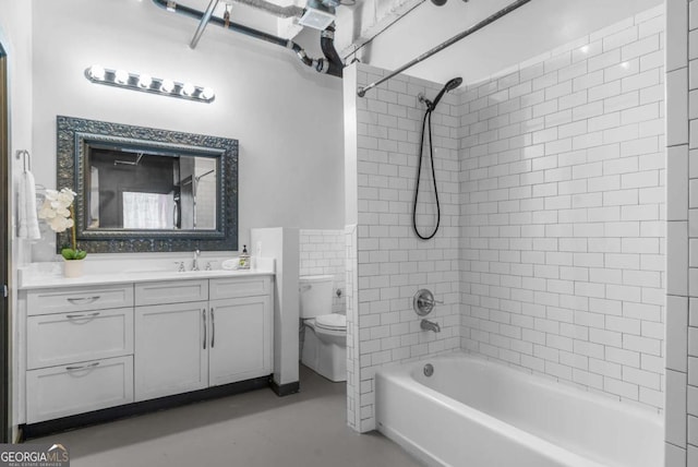 full bathroom with tiled shower / bath combo, vanity, and toilet