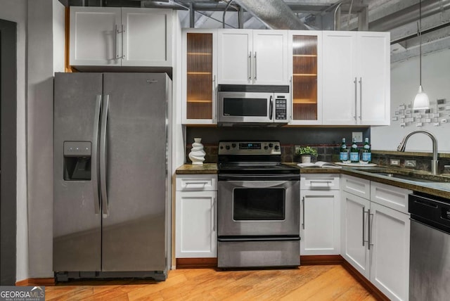 kitchen with white cabinetry, appliances with stainless steel finishes, and sink