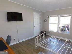 unfurnished bedroom featuring dark hardwood / wood-style flooring