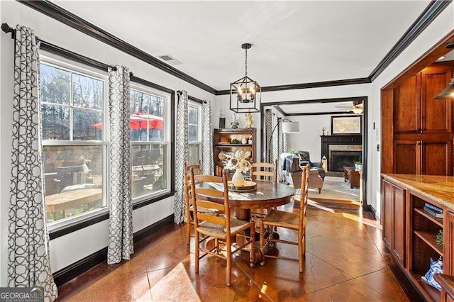 dining space with crown molding and a chandelier