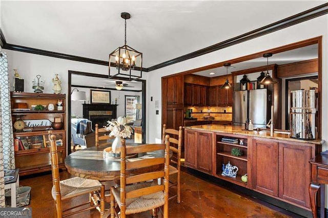 dining area featuring an inviting chandelier and crown molding