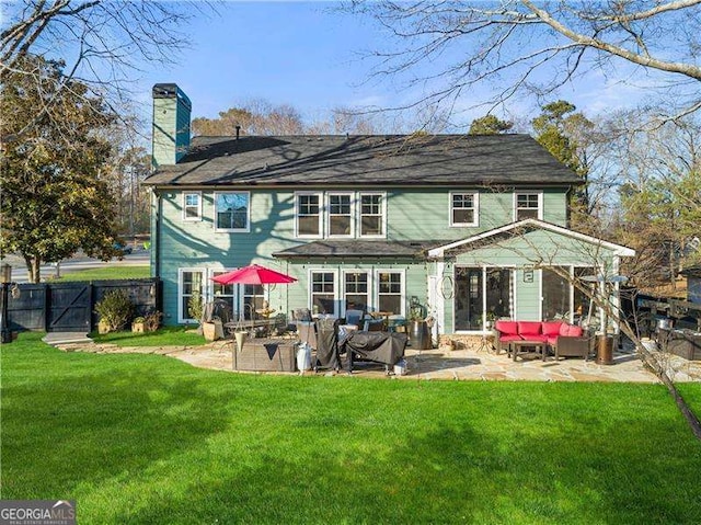 rear view of property featuring an outdoor hangout area, a yard, and a patio area