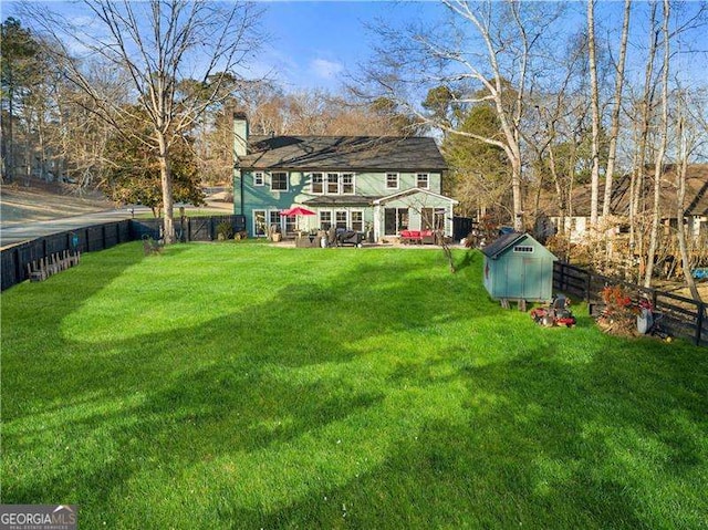 view of yard featuring a storage shed and a patio