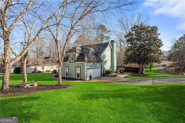 view of front of home featuring a garage and a front yard