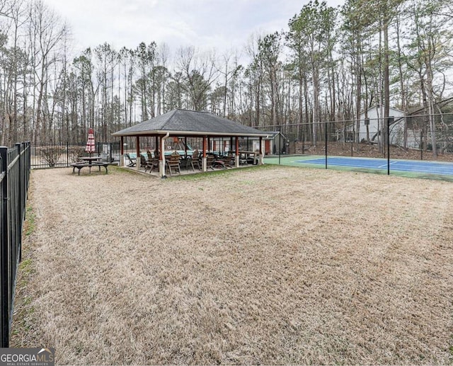 view of property's community featuring tennis court and a gazebo