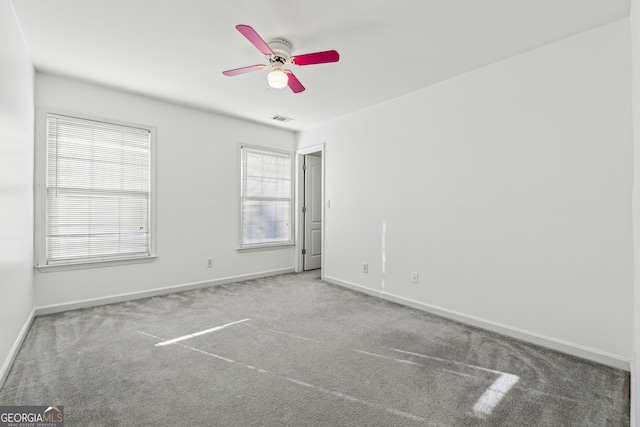 carpeted empty room featuring ceiling fan