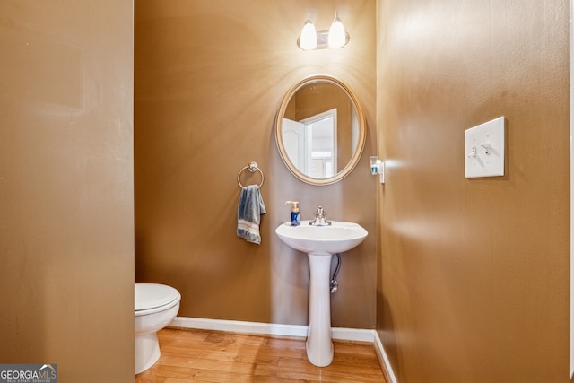 bathroom with wood-type flooring and toilet