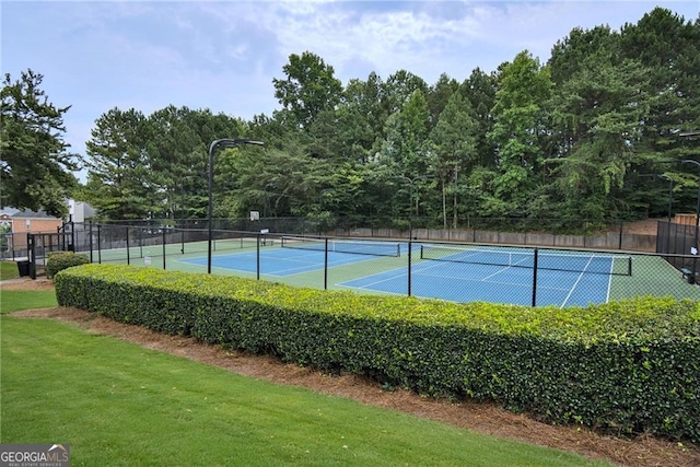 view of sport court featuring a lawn