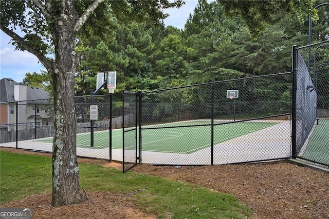 view of basketball court with a yard