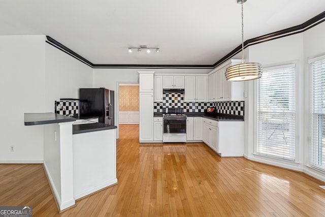 kitchen featuring white cabinets, decorative backsplash, hanging light fixtures, white range with gas cooktop, and black fridge