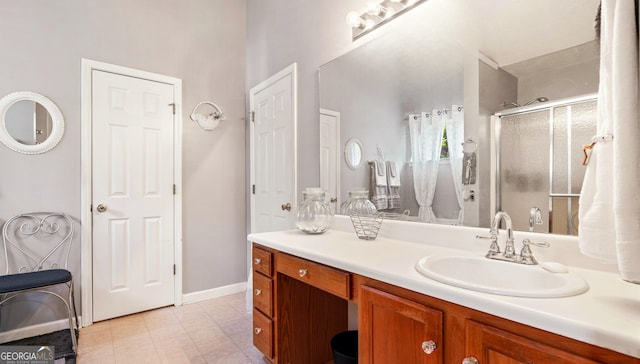 bathroom featuring vanity and an enclosed shower