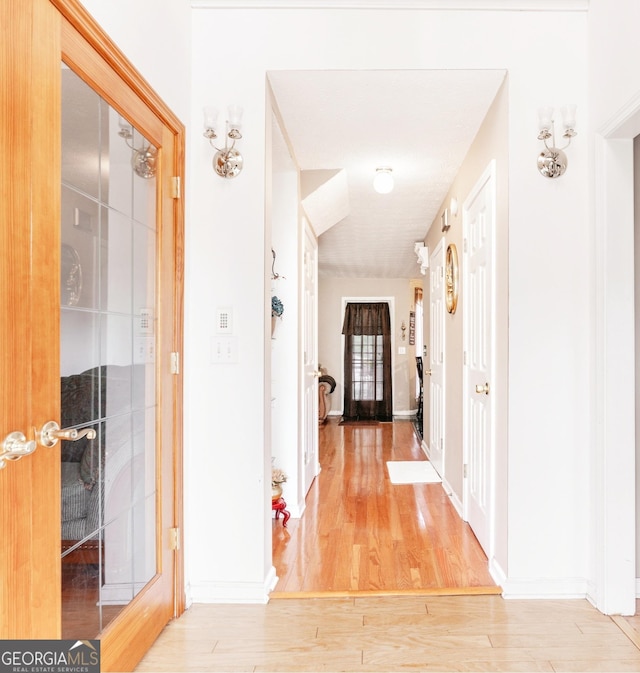 corridor featuring wood-type flooring