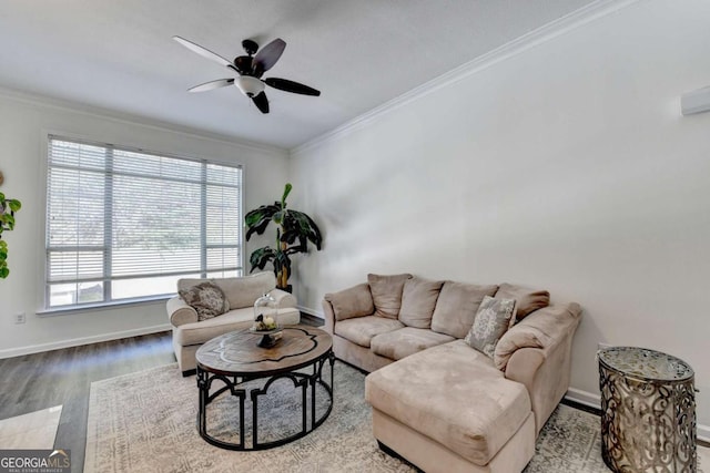 living room featuring ceiling fan, ornamental molding, and light wood-type flooring