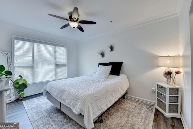 bedroom with ceiling fan, ornamental molding, and hardwood / wood-style floors