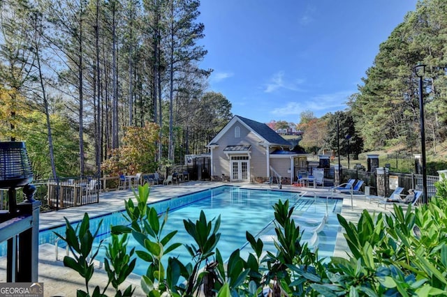 view of swimming pool featuring an outdoor structure and a patio