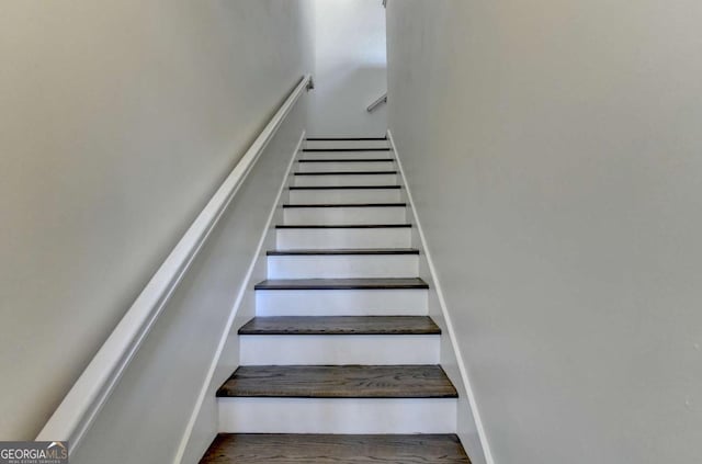 stairs featuring hardwood / wood-style floors