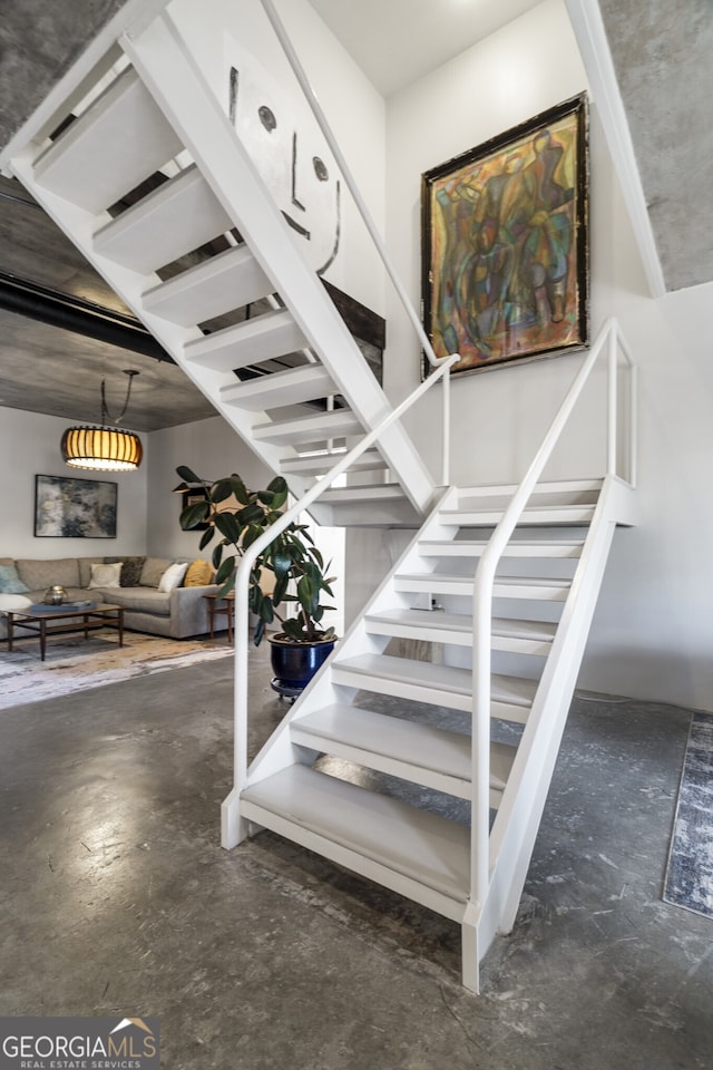 staircase with concrete flooring