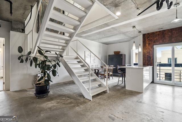 staircase with concrete floors