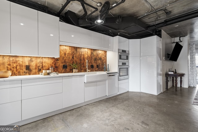 kitchen featuring stainless steel appliances and white cabinetry