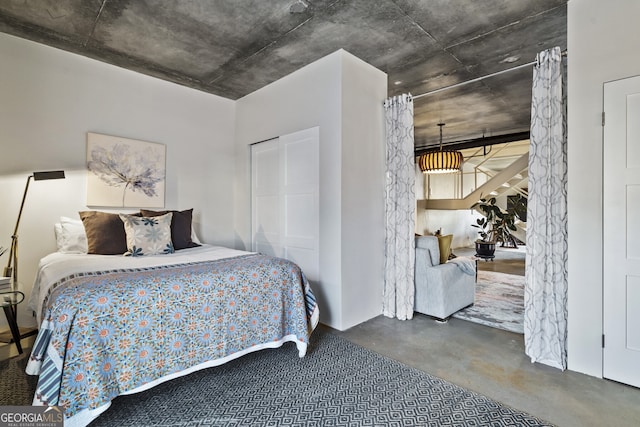 bedroom featuring concrete floors