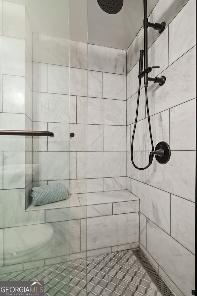 bathroom with a tile shower