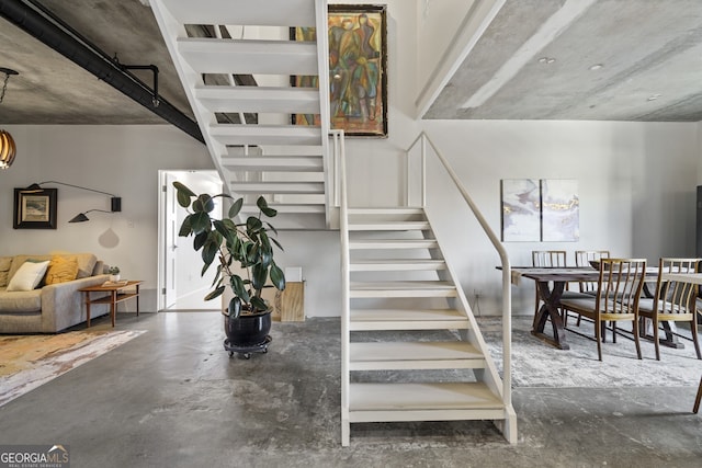 stairway with concrete flooring