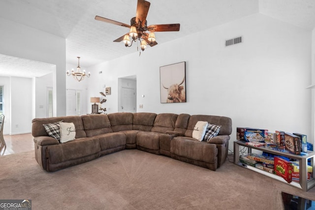 living room featuring carpet, ceiling fan with notable chandelier, lofted ceiling, and a textured ceiling