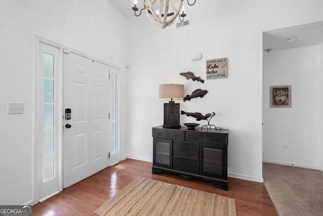 foyer featuring a chandelier and hardwood / wood-style floors