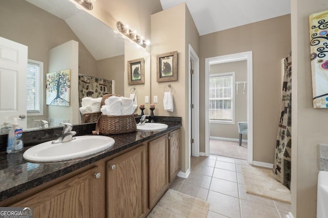 bathroom featuring vanity, tile patterned flooring, and lofted ceiling