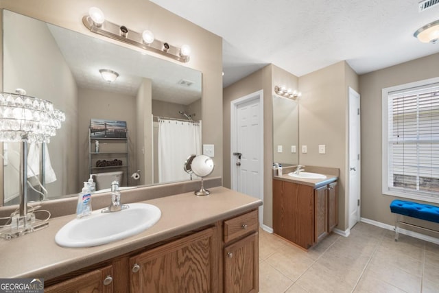 bathroom with tile patterned floors and vanity