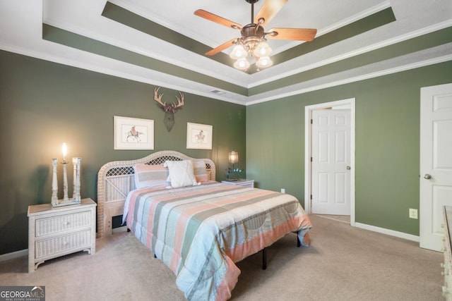 carpeted bedroom with a raised ceiling, crown molding, and ceiling fan