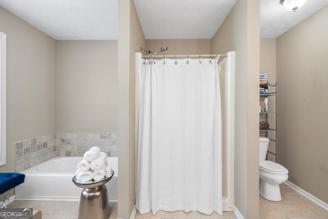 bathroom featuring a textured ceiling, tile patterned floors, plus walk in shower, and toilet