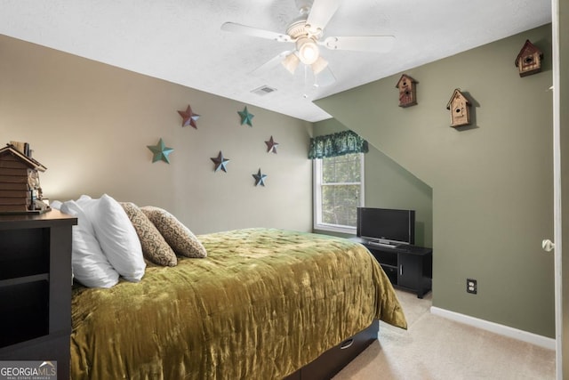 bedroom featuring light carpet and ceiling fan