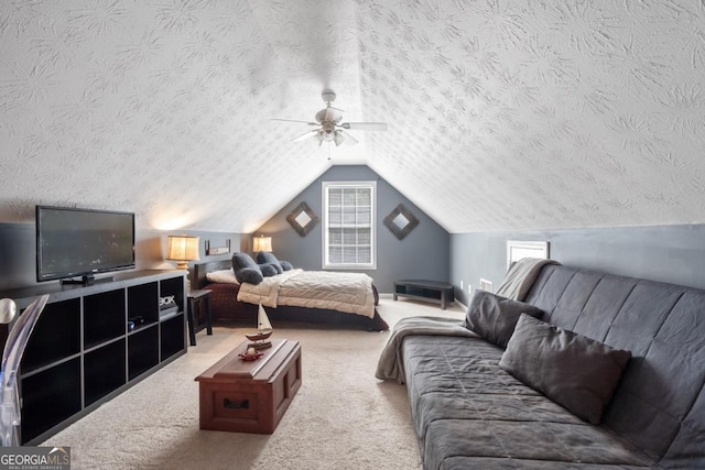 bedroom with ceiling fan, vaulted ceiling, a textured ceiling, and carpet