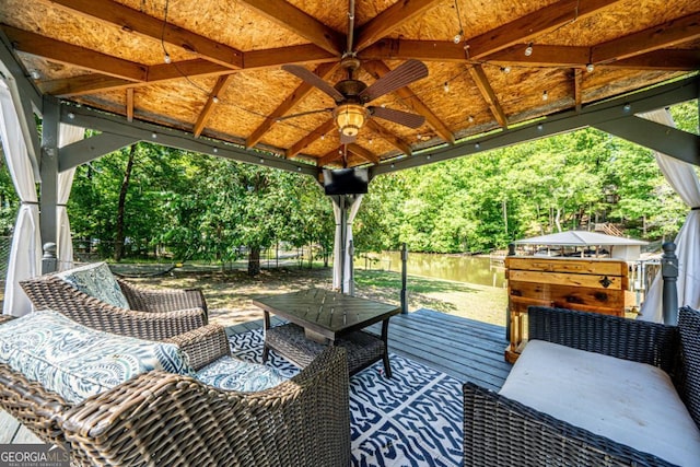 view of patio featuring a gazebo, a water view, and ceiling fan