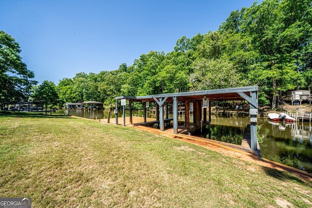 view of yard featuring a boat dock and a water view