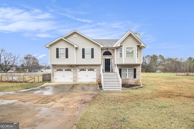 bi-level home with a garage and a front yard