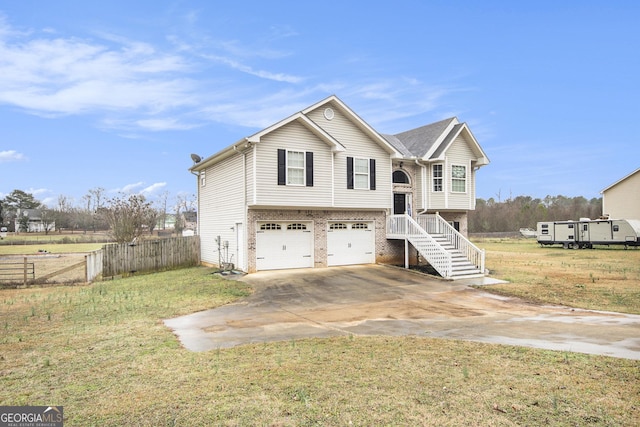 bi-level home featuring a garage and a front lawn