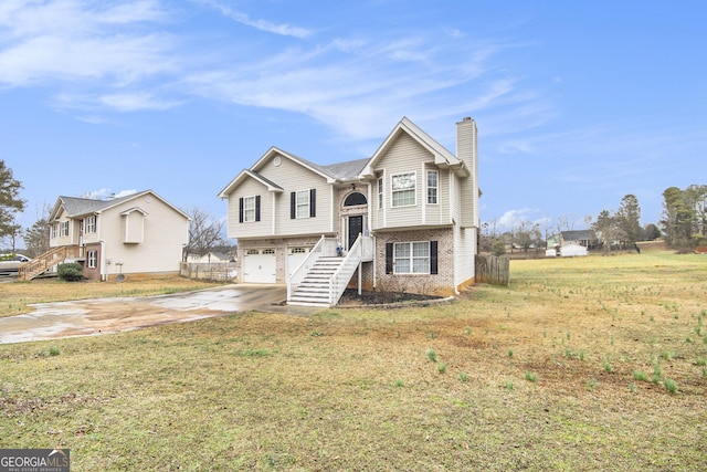 split foyer home with a garage and a front yard