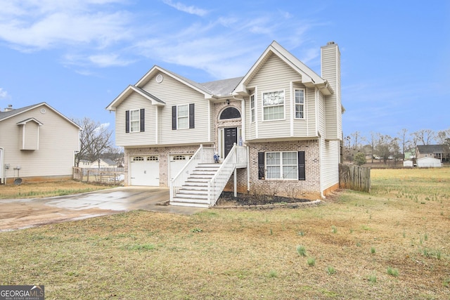 raised ranch with a garage and a front lawn