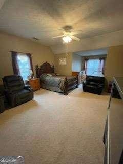 carpeted bedroom with lofted ceiling and ceiling fan