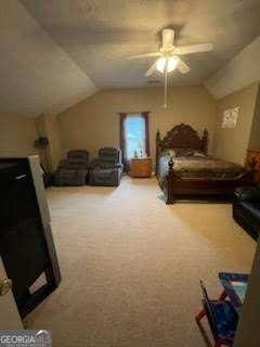 carpeted bedroom with ceiling fan and lofted ceiling