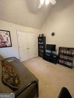 interior space featuring ceiling fan, lofted ceiling, and a closet