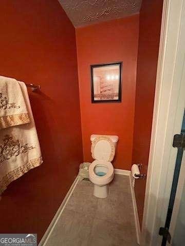 bathroom featuring toilet and a textured ceiling