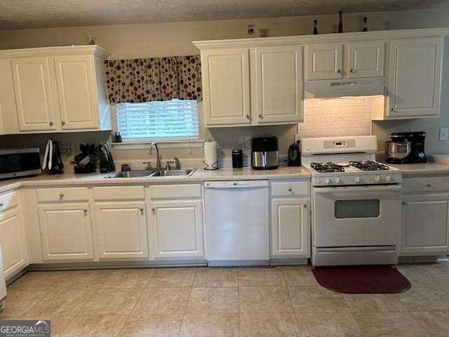 kitchen featuring white cabinetry, white appliances, sink, and a textured ceiling