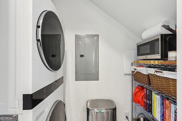 washroom featuring stacked washer / dryer and electric panel