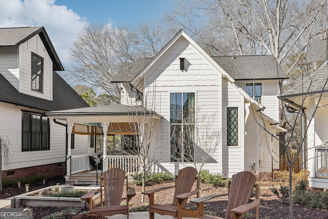 rear view of property with a porch