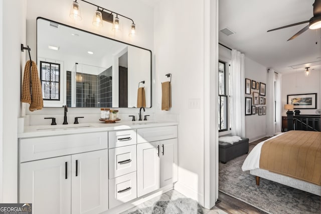 bathroom with vanity, wood-type flooring, a shower with door, and ceiling fan