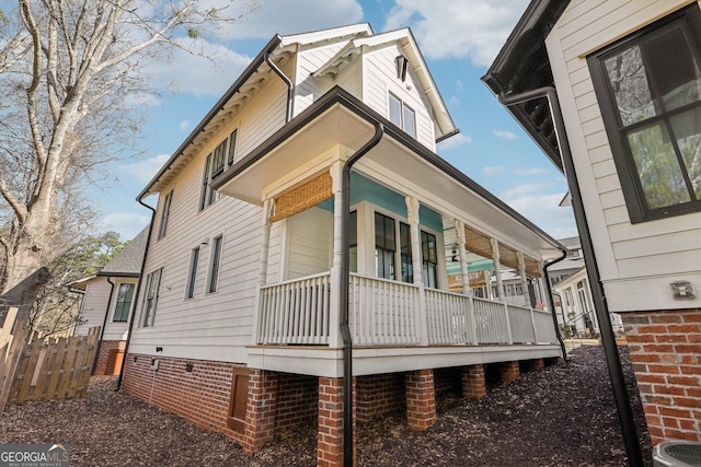 view of side of property with central AC unit and covered porch